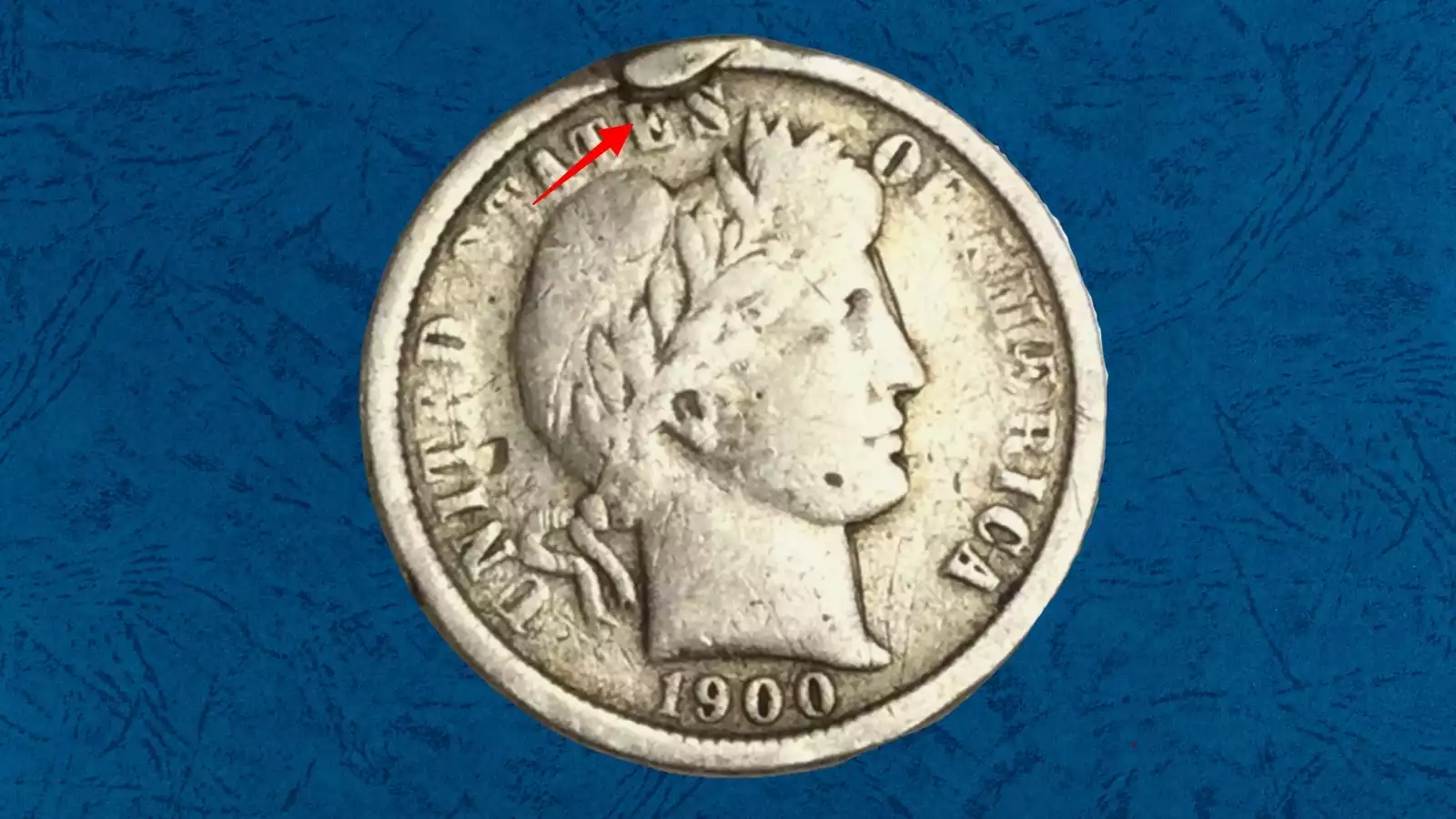 1900 Barber dime with die cud error showing raised blob of metal connected to rim where die broke away